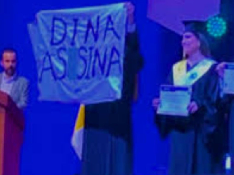 Estudiante de la PUCP exhibe cartel contra Dina Boluarte durante ceremonia de graduación.